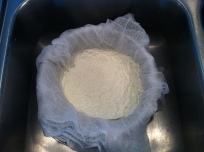 Straining curds and whey.